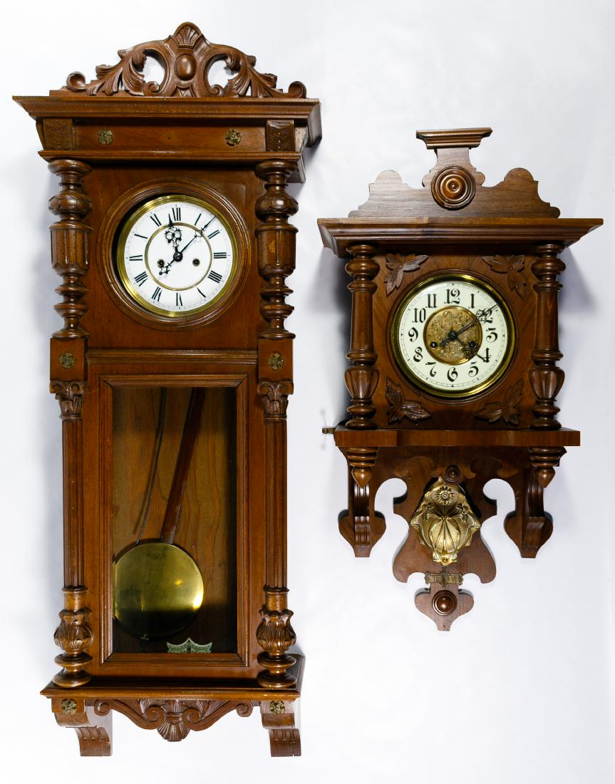 Gustav Becker Wall Clock Assortment: Gustav Becker Wall Clock Assortment Both having carved walnut cases, brass and porcelain dials, brass pendulums Condition: Very Good to Good, Large clock decorative top is not attached, medallion is m