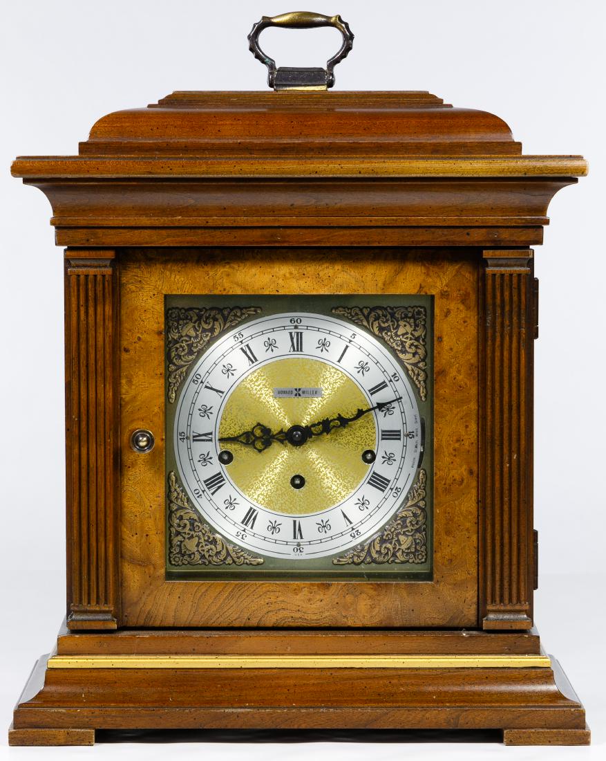 Howard Miller Mantel Clock: Howard Miller Mantel Clock Key-wound, hardwood case, glass sides and mirrored back reveal the movement; brass hardware; including key included Condition: Good, light sign of wear around the corners, s