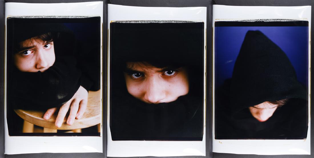 Dawoud Bey (American, b.1953) Portrait Photographs: Dawoud Bey (American, b.1953) Portrait Photographs (3) undated and unsigned color portraits of a person in a hooded garment Condition: Very Good, light smudges; image with wood furniture having rough 