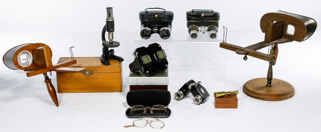 Stereoscope and Binocular Assortment: Stereoscope and Binocular Assortment Two stereoscopes with slides including a 1940 View-Master with reels in original box, three mini binoculars two with case, wire rimmed glasses, a microscope in woo