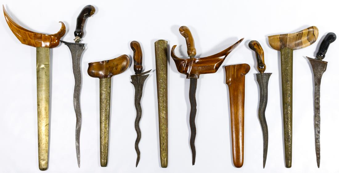 Indonesian Kris Dagger and Sheath Assortment: Indonesian Kris Dagger and Sheath Assortment Five kris or keris, all having distinctive damascene blade-patterning; four having metal mounted wooden sheaths and one having a wooden sheath Condition: V