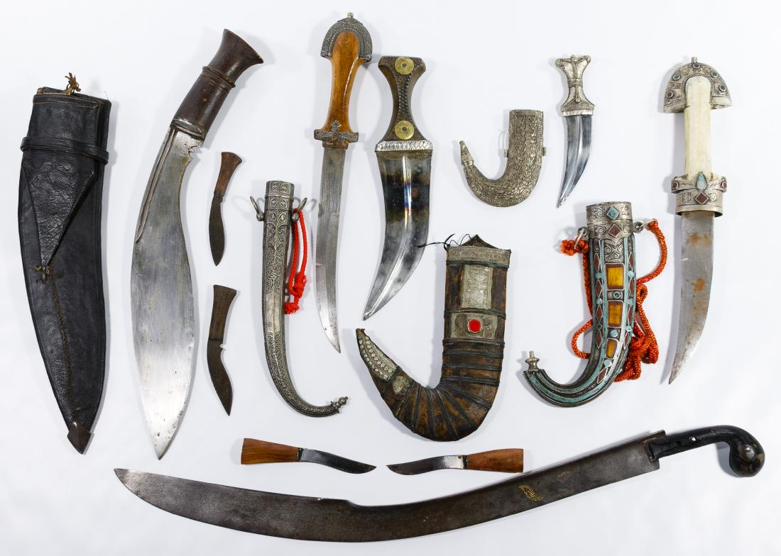 Islamic Edged Weapon Assortment: Islamic Edged Weapon Assortment Including an Ottoman Kilij Pala curved sword with inlaid gold inscription; four Islamic daggers or jambiya in their ornate curved sheaths having decorative metal with t