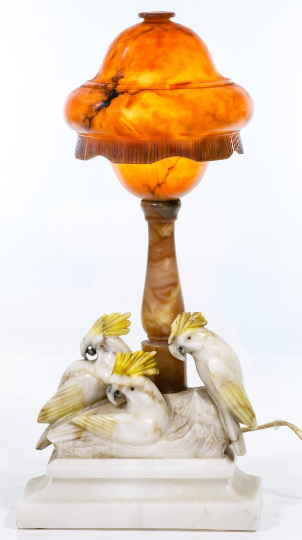 Carved Alabaster Table Lamp and Shade: Carved Alabaster Table Lamp and Shade c.1910; Art Deco style lamp base in cream color stone with three carved cockatiels; golden color stone pillar supporting a bell-shaped golden color shade Conditio