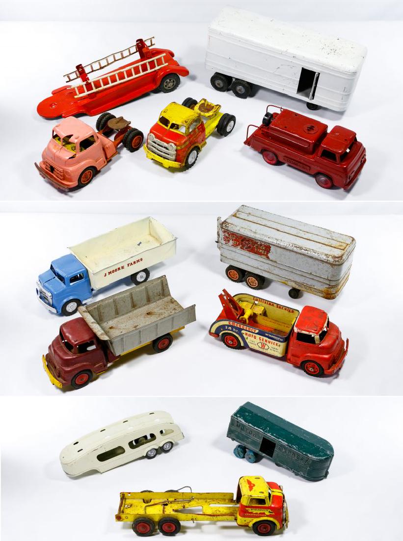 Wyandotte Toy Trucks Assortment: Wyandotte Toy Trucks Assortment Twelve items including a Wyandotte pressed steel truck and trailer, a Wyandotte plastic and steel truck and trailer, a Wyandotte plastic and steel tow truck, a Wyandott
