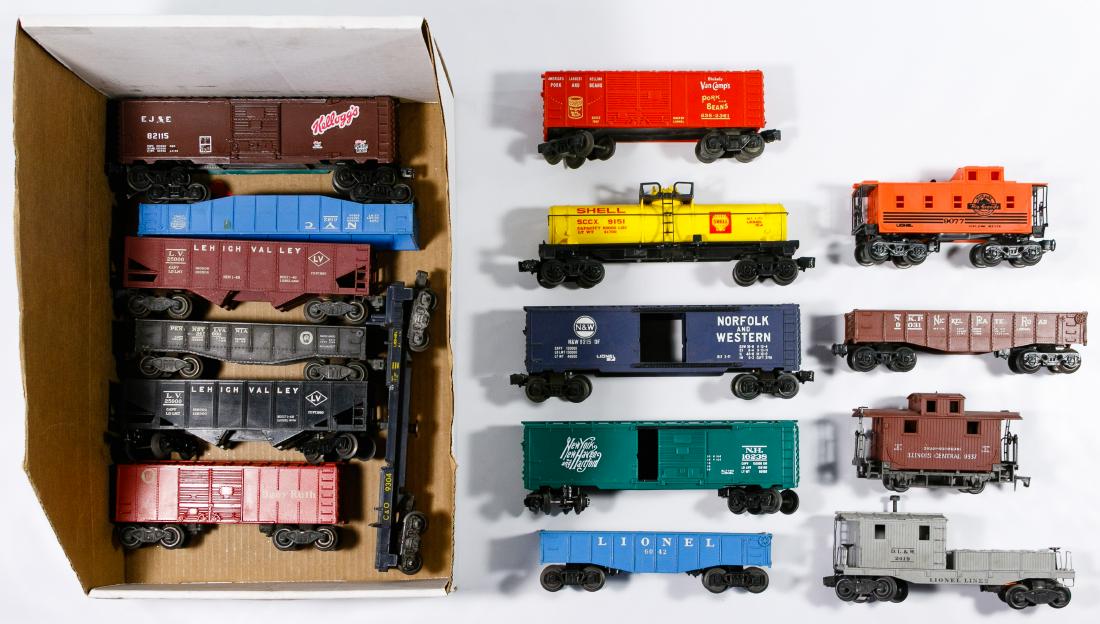 Model Train and Part Assortment: Model Train and Part Assortment Sixteen plastic, 'O' gauge 'Lionel' freight train cars including oil tanker, box cars, flat cars as well as a box of miscellaneous parts Condition: Good, paint loss, sc