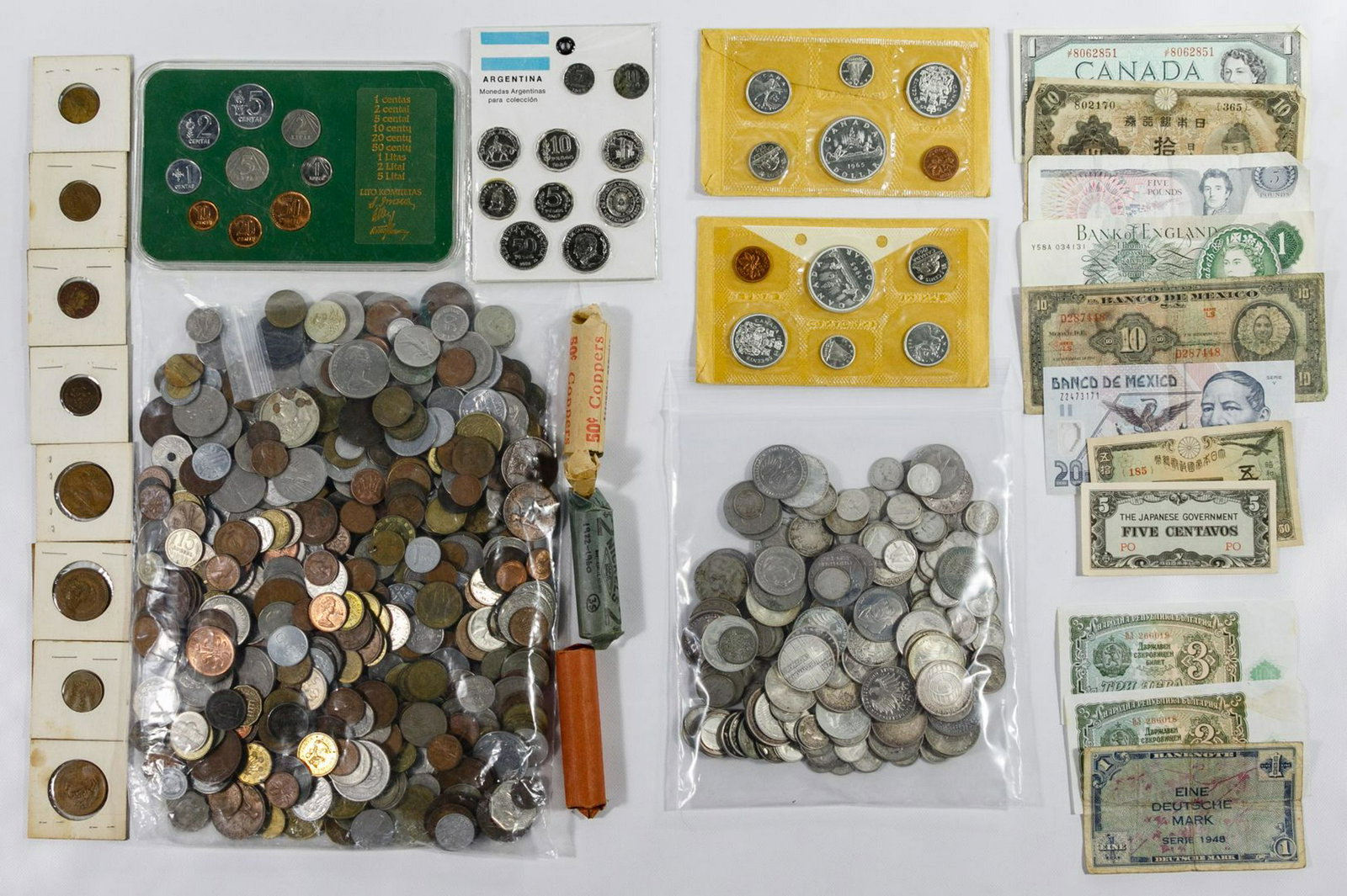 World: Coin Assortment: World: Coin Assortment Including examples from Canada, Germany and France ; silver noted weighing 32.95 ozt.; together with an assortment of foreign currency Category: World Coins & Currency > World C