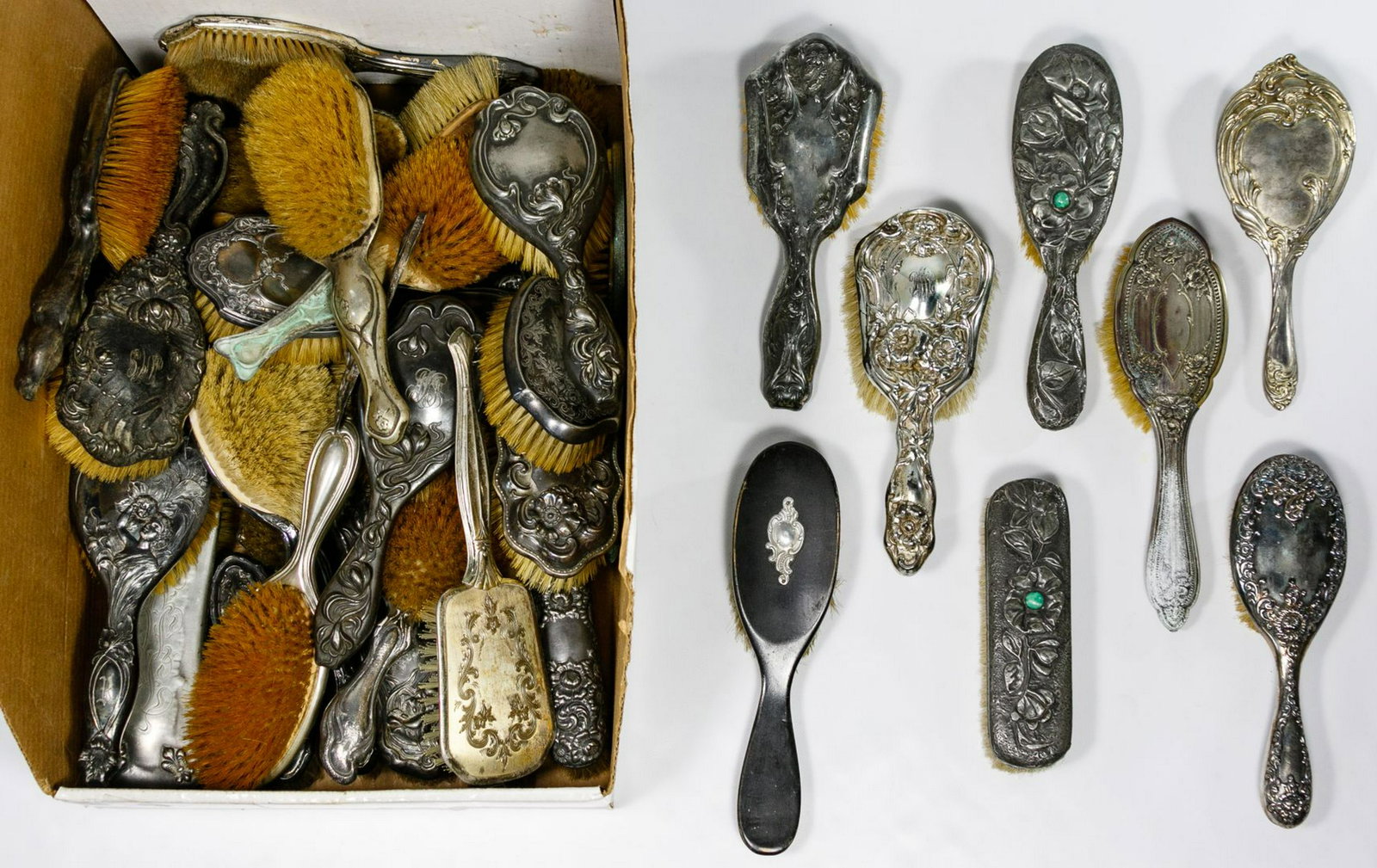 Silverplate and Wood Vanity Brush Assortment: Silverplate and Wood Vanity Brush Assortment Forty-one vanity brushes; a mix of floral, face and scroll motifs; two having a green stone inset Condition: Very Good to Fair, overall light to moderate w