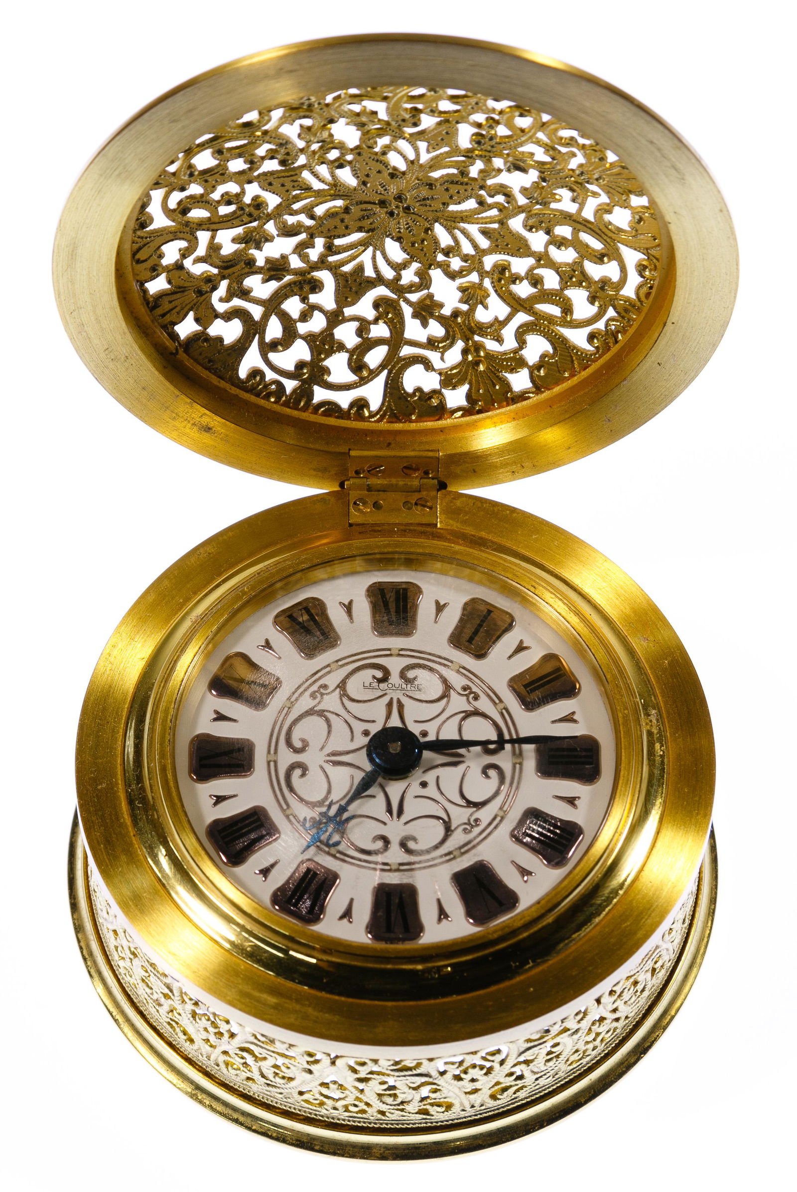Le Coultre Brass Filigree Travel / Desk Clock: Le Coultre Brass Filigree Travel / Desk Clock Undated, stamped on back Le Coultre Swiss Model 440, clock gold-tone, enamel face, silver and black Roman numerals, black hands, time set and wind on back