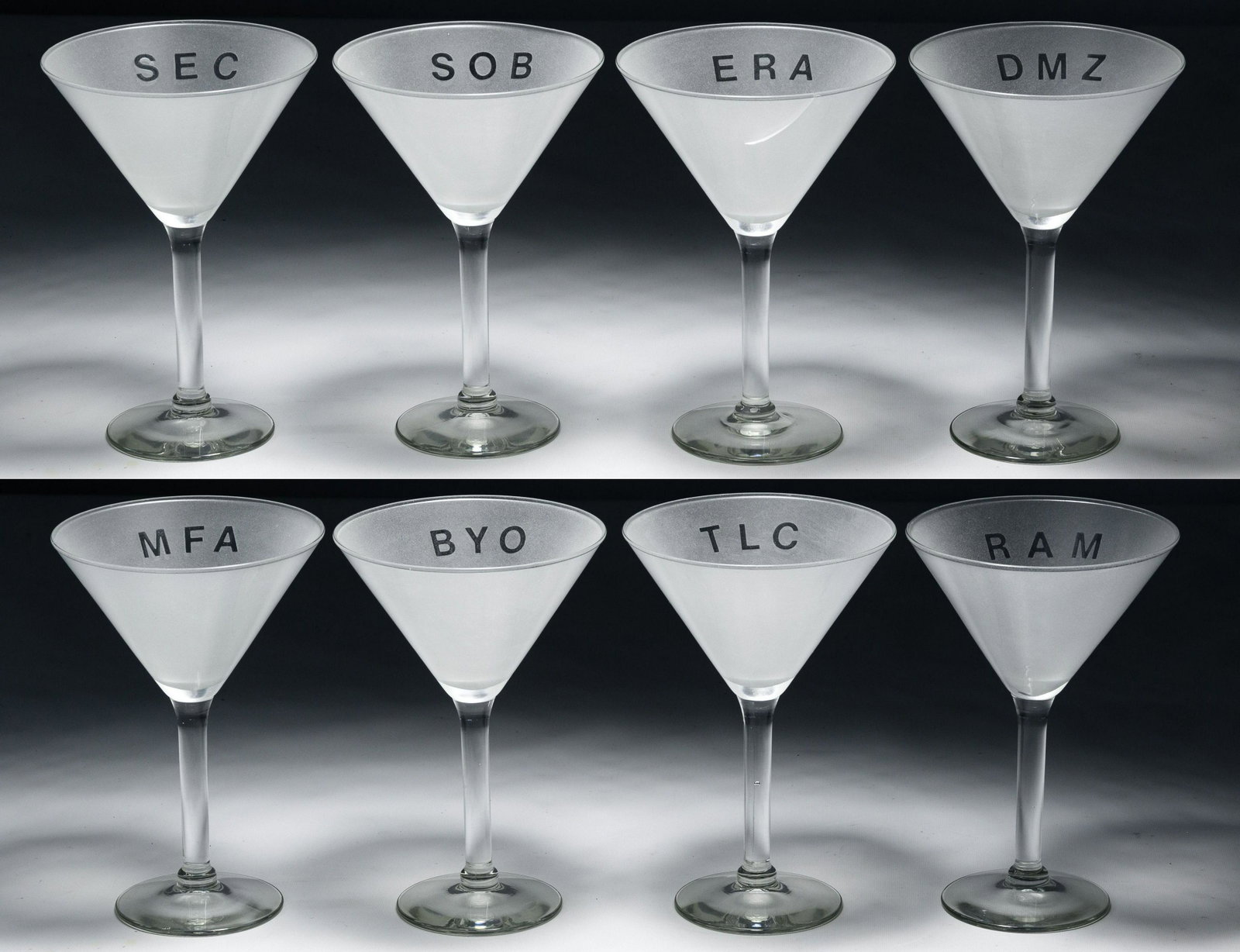 Adam Brooks (American, b.1959) Martini Glasses: Adam Brooks (American, b.1959) Martini Glasses Eight frosted glass martini glasses having colloquial abbreviation inscriptions Condition: Good, overall light to moderate wear, crack in a glass Height: