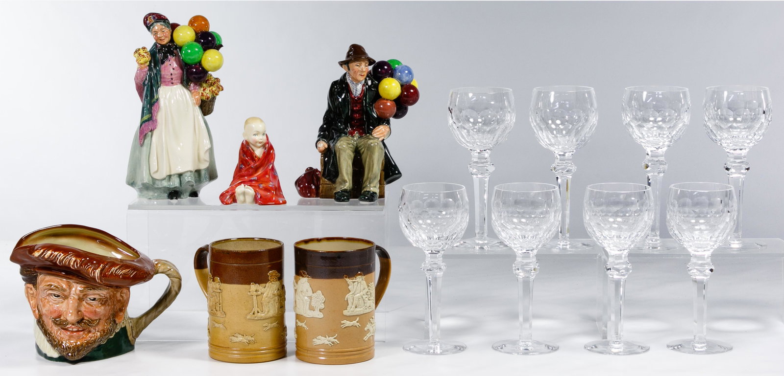 Waterford Crystal and Royal Doulton Assortment: Waterford Crystal and Royal Doulton Assortment Fourteen items including (8) Curraghmore white wine glasses; 'Biddy Pennyfarthing', 'The Balloon Man', 'This Little Pig', 'Sir Francis Drake' toby jug / 