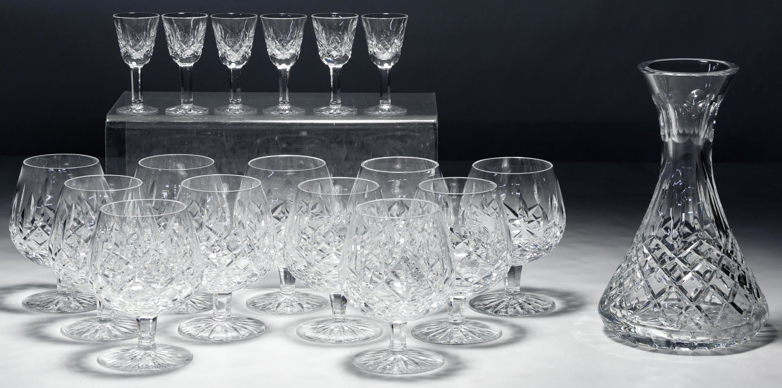 Waterford Crystal Lismore Assortment: Waterford Crystal Lismore Assortment Including eleven brandy snifters, six cordial glasses and a water carafe Condition: Very Good to Fair, one snifter having chip on bottom rim; one snifter and caraf