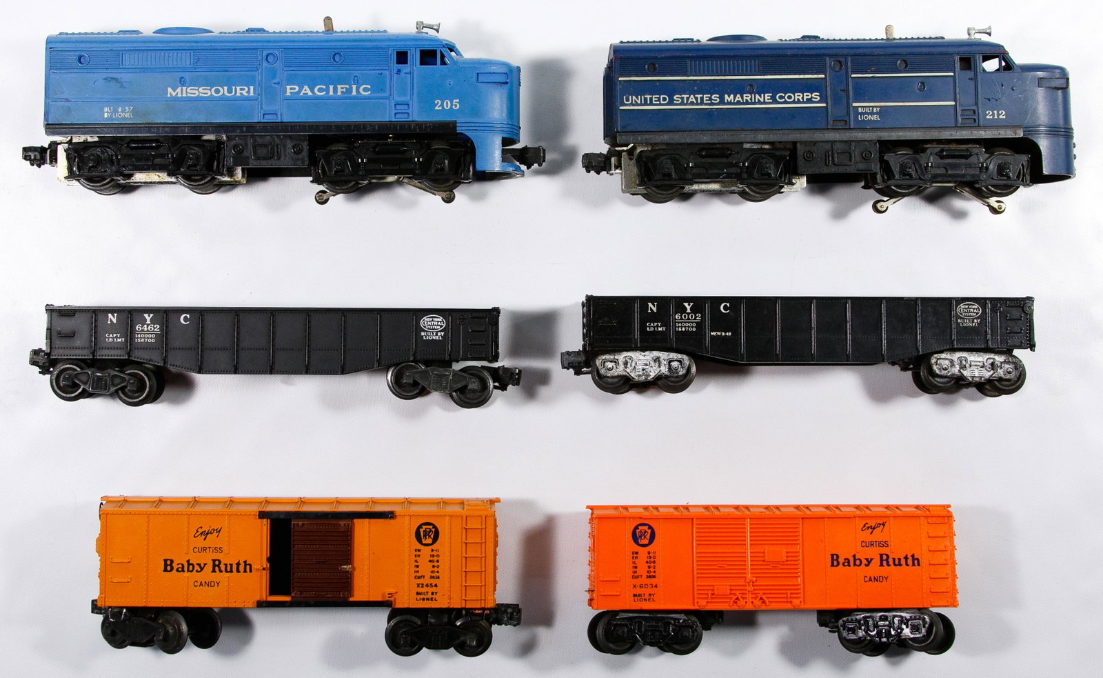Lionel Model Train Assortment: Lionel Model Train Assortment Including Baby Ruth (#x-6034, #x-2454, #6004), Marine Corps powered A unit engine #212, Missouri Pacific powered A unit engine #205 having early variation with metal supp