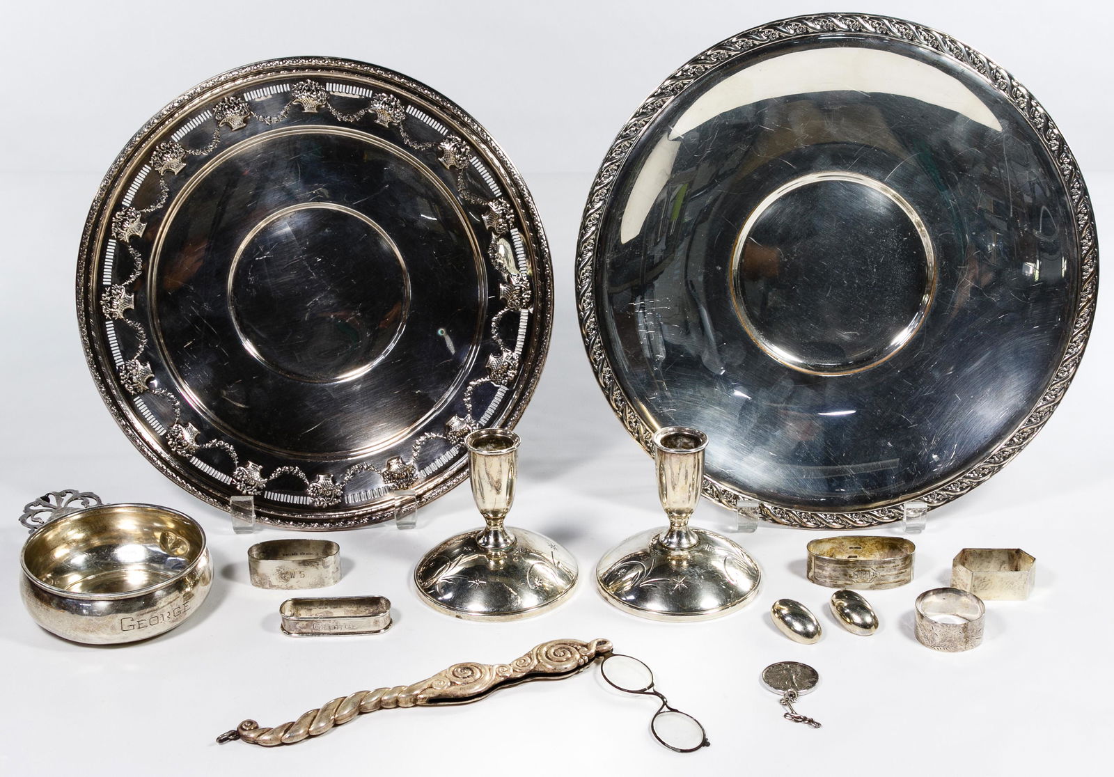 Sterling Silver Hollowware Assortment: Sterling Silver Hollowware Assortment Nine items including opera glasses, porringer, five napkin rings and two weighted candleholders; together with two sterling earrings, 1942 Walking Liberty 50c and