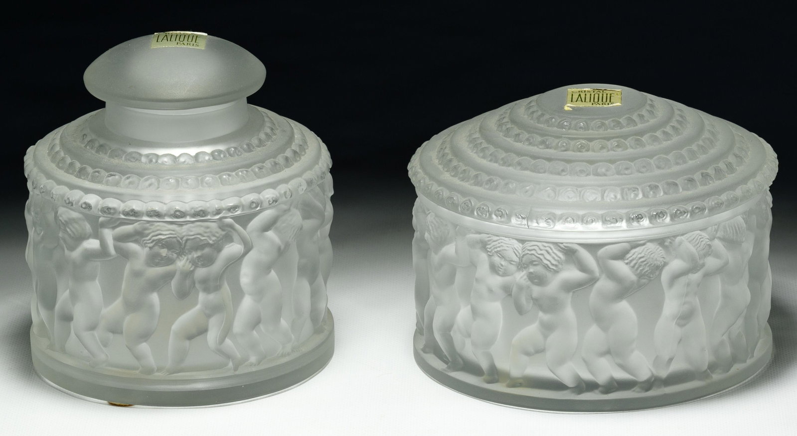 Lalique Crystal 'Les Enfants' Frosted Glass Jars: Lalique Crystal 'Les Enfants' Frosted Glass Jars Two items including powder jar and perfume bottle, both having etched marks on the underside reading 'Lalique France' and retaining 'Made in France' an