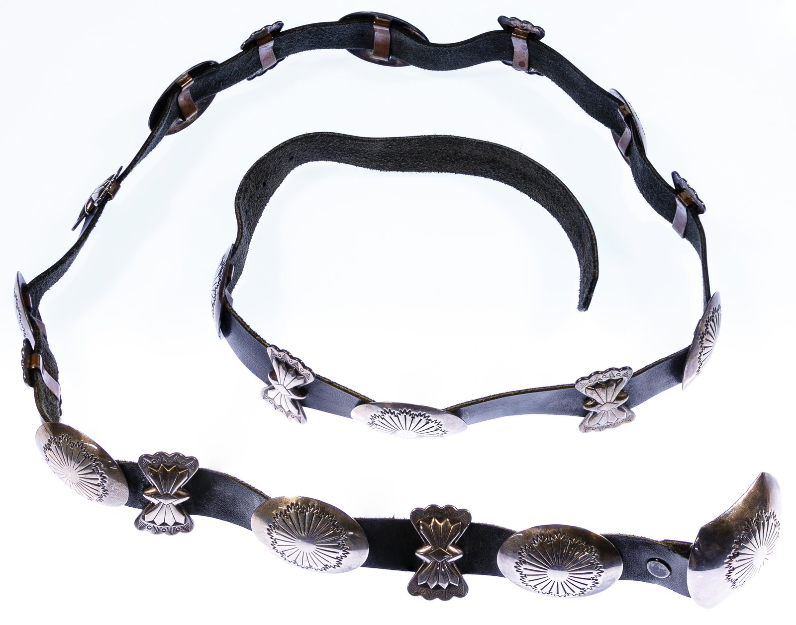 Native American (Navajo) J. Wright Sterling Silver: Native American (Navajo) J. Wright Sterling Silver Concho Belt Navajo concho belt buckle and nineteen alternating concho ovals and bows, all having stamped designs, mounted on black leather belt; mark