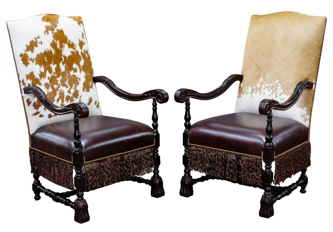 Western Style High-back Armchairs: Western Style High-back Armchairs Two chairs; matched dark stained oak frames, each having a unique hide back, leather seats and leather tassels; purchased at Marc Taggart and Company, Cody, WY Condit