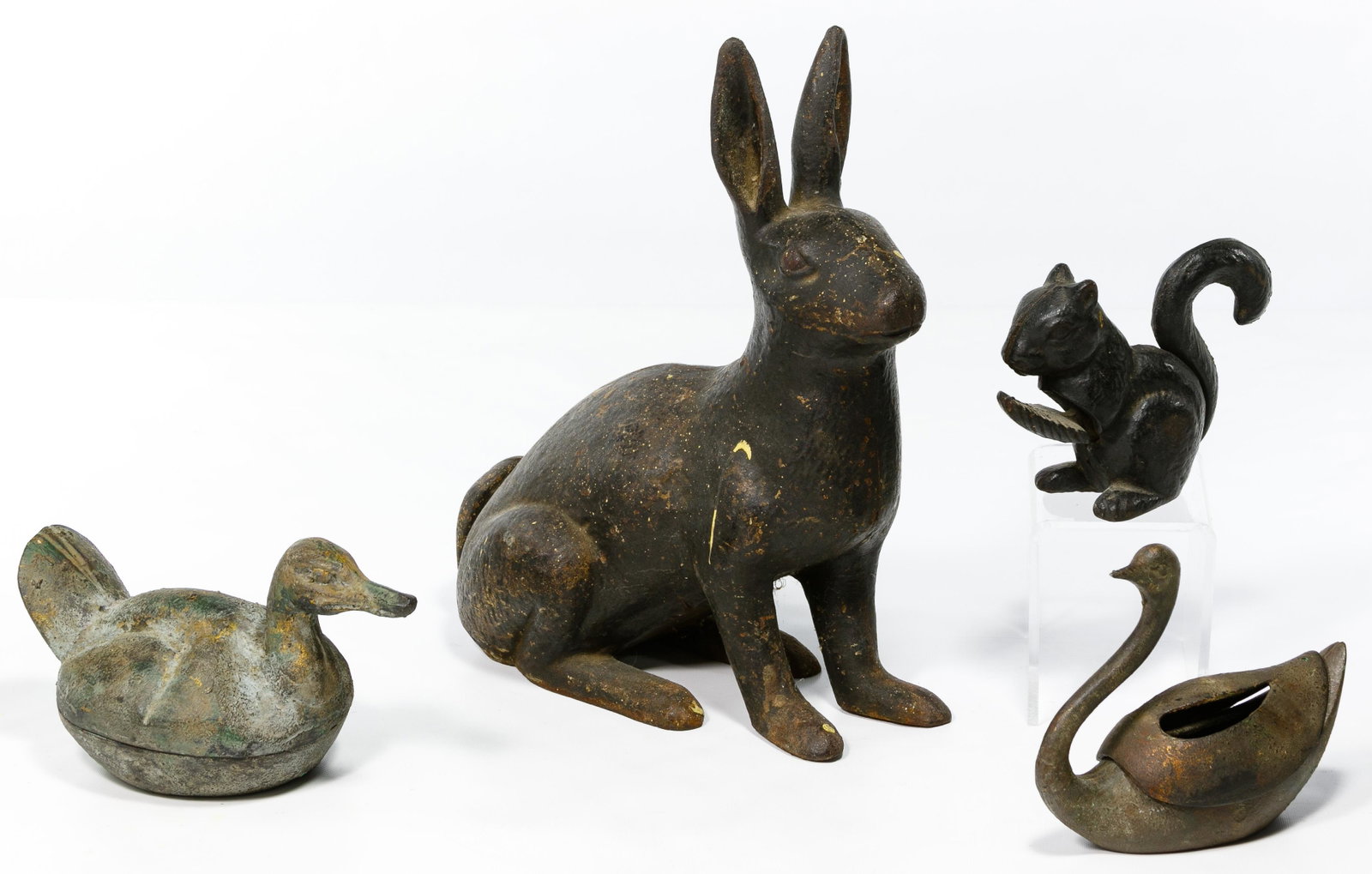 Cast Iron Animal Form Assortment: Cast Iron Animal Form Assortment Four items including a squirrel nutcracker, a swan incense burner, a duck lidded box and a rabbit garden ornament Condition: Very Good to Fair, overall light wear and 