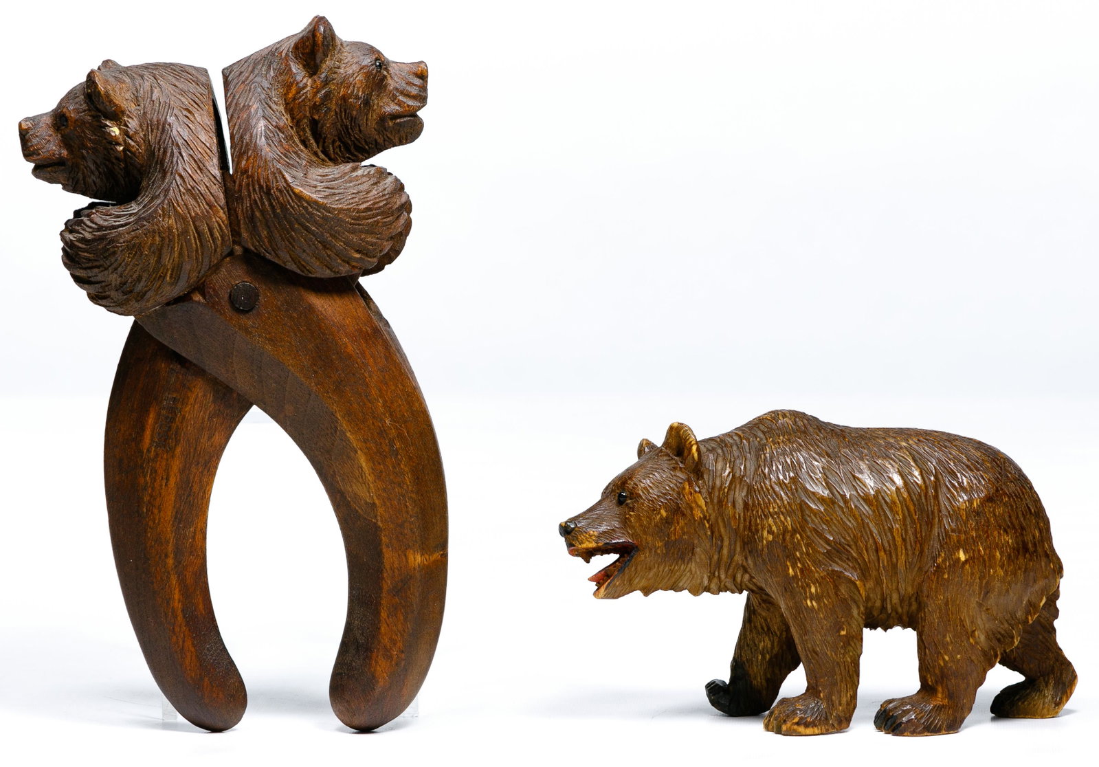 Black Forest Bear Nut Cracker and Figurine: Black Forest Bear Nut Cracker and Figurine Double-headed bear carved nutcraker marked Depose on handle and carved walking bear having mouth open showing teeth Condition: Very Good, overall light wear 