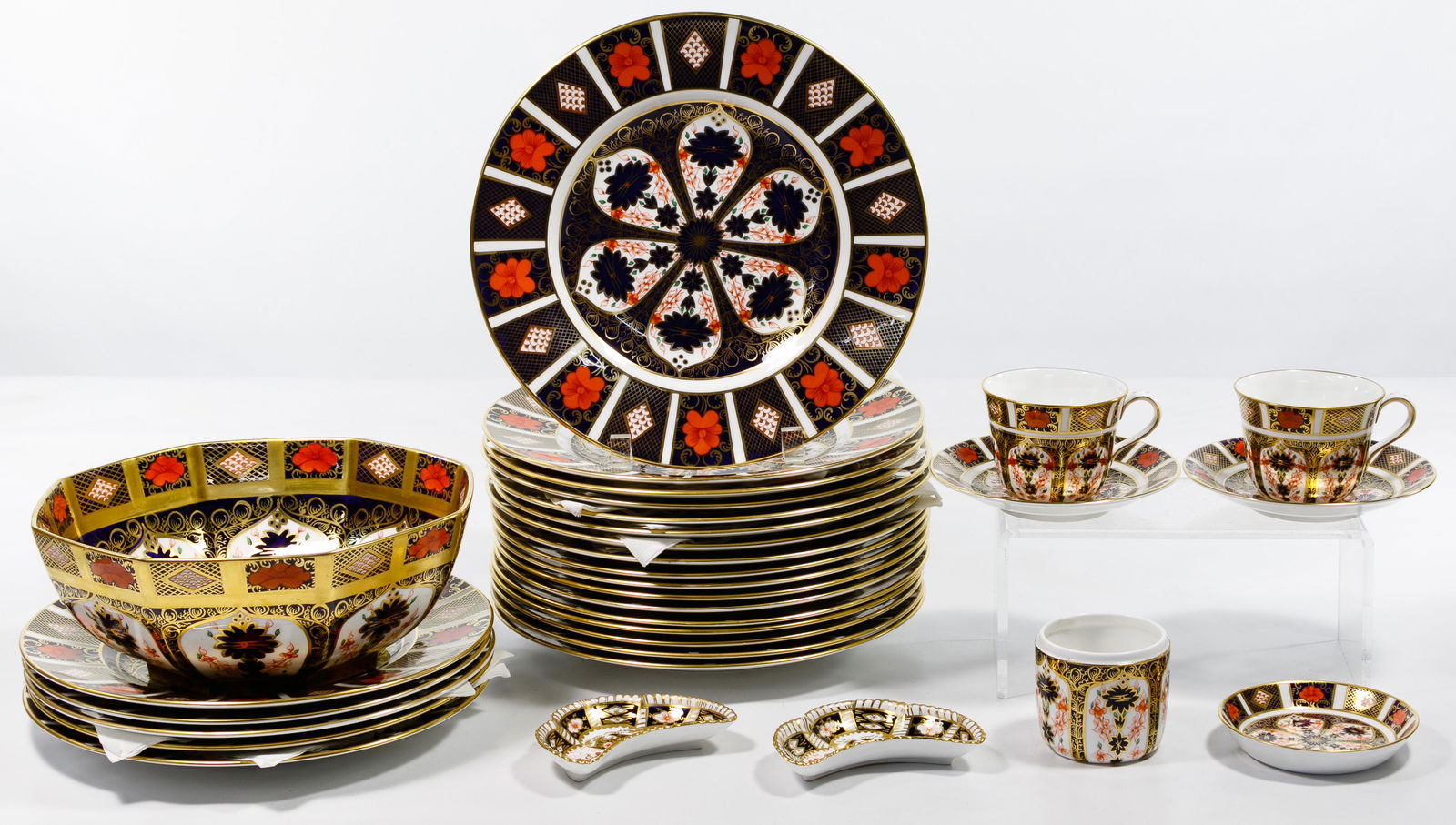 Royal Crown Derby #1128: Royal Crown Derby #1128 'Old Imari' China Assortment Thirty-one items including twenty-two dinner plates, a large serving bowl, two cup and saucer sets, a mustard pot with tray and two crescent shaped