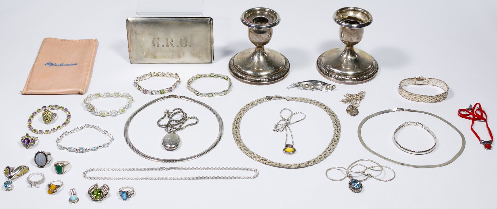 Sterling Silver Jewelry and Candle Holder Assortment: Sterling Silver Jewelry and Candle Holder Assortment Including necklaces, rings, pendants and an Elgin American cigarette holder as well as a pair of weighted candle holders; all marked 'sterling' or 