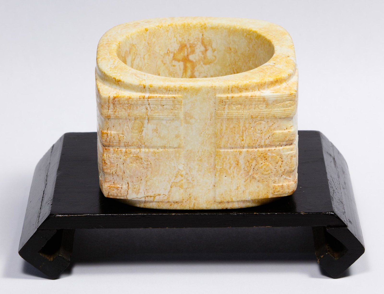 Chinese Carved Jadeite Jade Cong with Stand: Chinese Carved Jadeite Jade Cong with Stand Column form sitting on a wood plinth having carved decorations Condition: Very Good, some natural pitting on the outside and inside of the item; overall lig