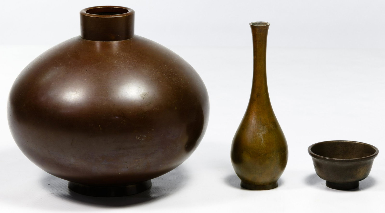 Japanese Bronze Vessel Assortment: Japanese Bronze Vessel Assortment Three items including a Meiji globular footed vase having a short, straight neck, a bottle vase in attenuated Tokkuri form and a small bowl; all marked on the undersi