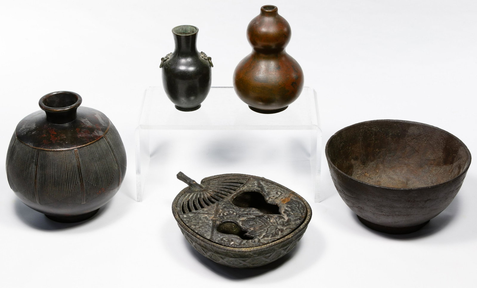 Japanese Metal Object Assortment: Japanese Metal Object Assortment Three Meiji bronze vases including a squat tokkuri having flattened shoulders with stylized lotus leaf decoration, a double gourd vase and Chinese style 'Hu' wine vess