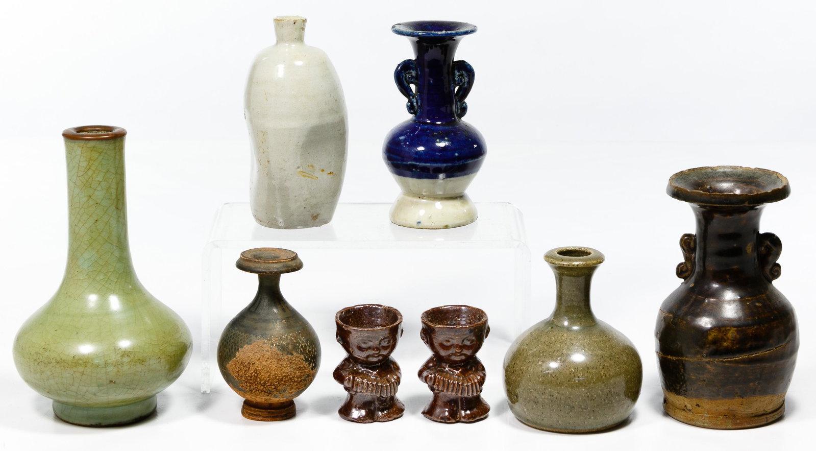 Japanese Pottery Assortment: Japanese Pottery Assortment Eight items including a low bottle by Bunichi Kaihatsu (Japanese, 1896-1966), a taller bottle in celadon glaze, two egg cups, a pinched sided bottle, two vases with applied