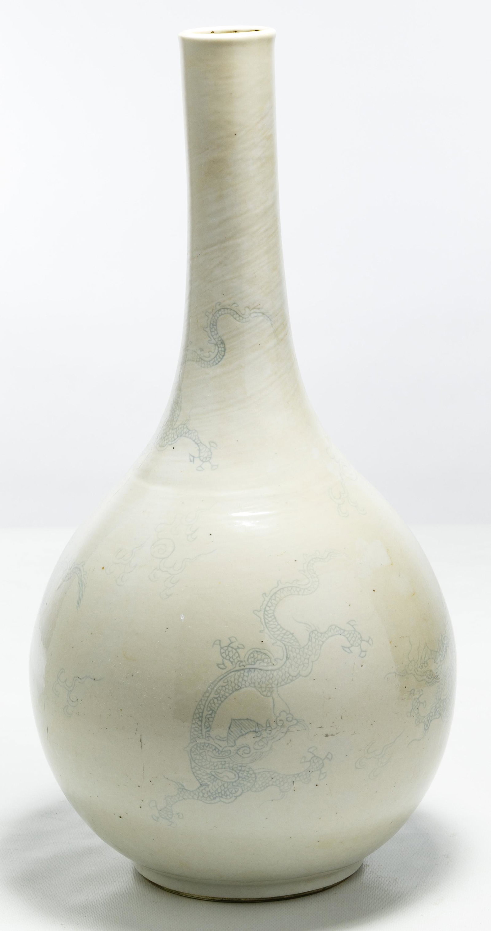 Korean Dragon Vase: Korean Dragon Vase Joseon or Chosun Dynasty bottle vase having five blue dragons under a thickly applied brushed-on white glaze Condition: Very Good, minor glaze irregularities typical of these wares;
