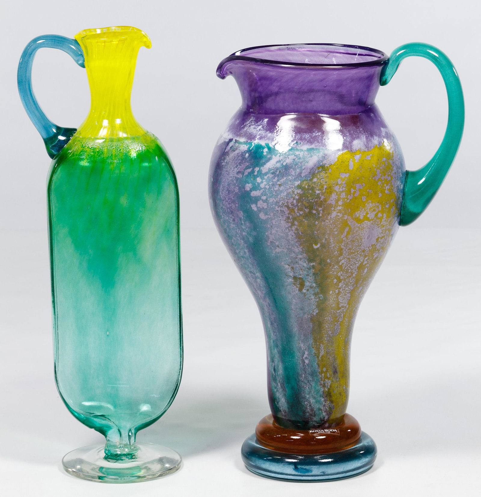 Kjell Engman for Kosta Boda Art Glass Pitchers: Kjell Engman for Kosta Boda Art Glass Pitchers Two items including a 'Cancan' pitcher and a 'Bon Bon' jug, both signed and numbered Condition: Very Good, no chips or cracks noted; Bon Bon jug shows se