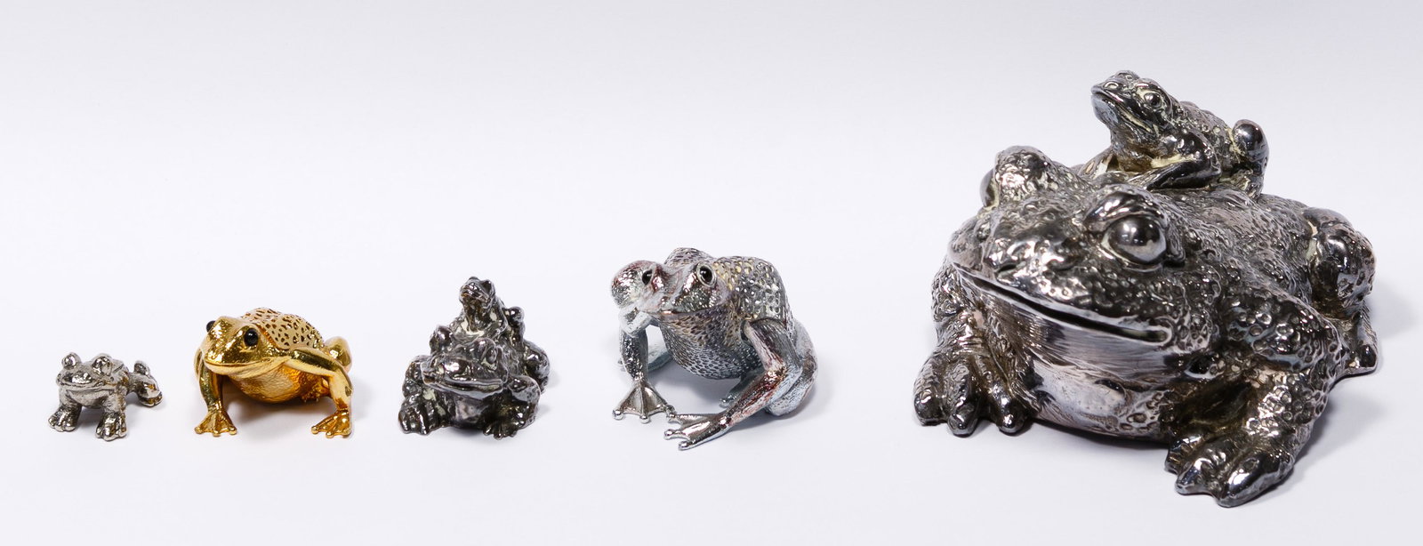 Christofle and Israel Frog Figurine Assortment: Christofle and Israel Frog Figurine Assortment Five items including three frogs marked '925' or acid tested as silver, purity unknown, one of which is marked 'Christofle' on underside, a gold-tone fro