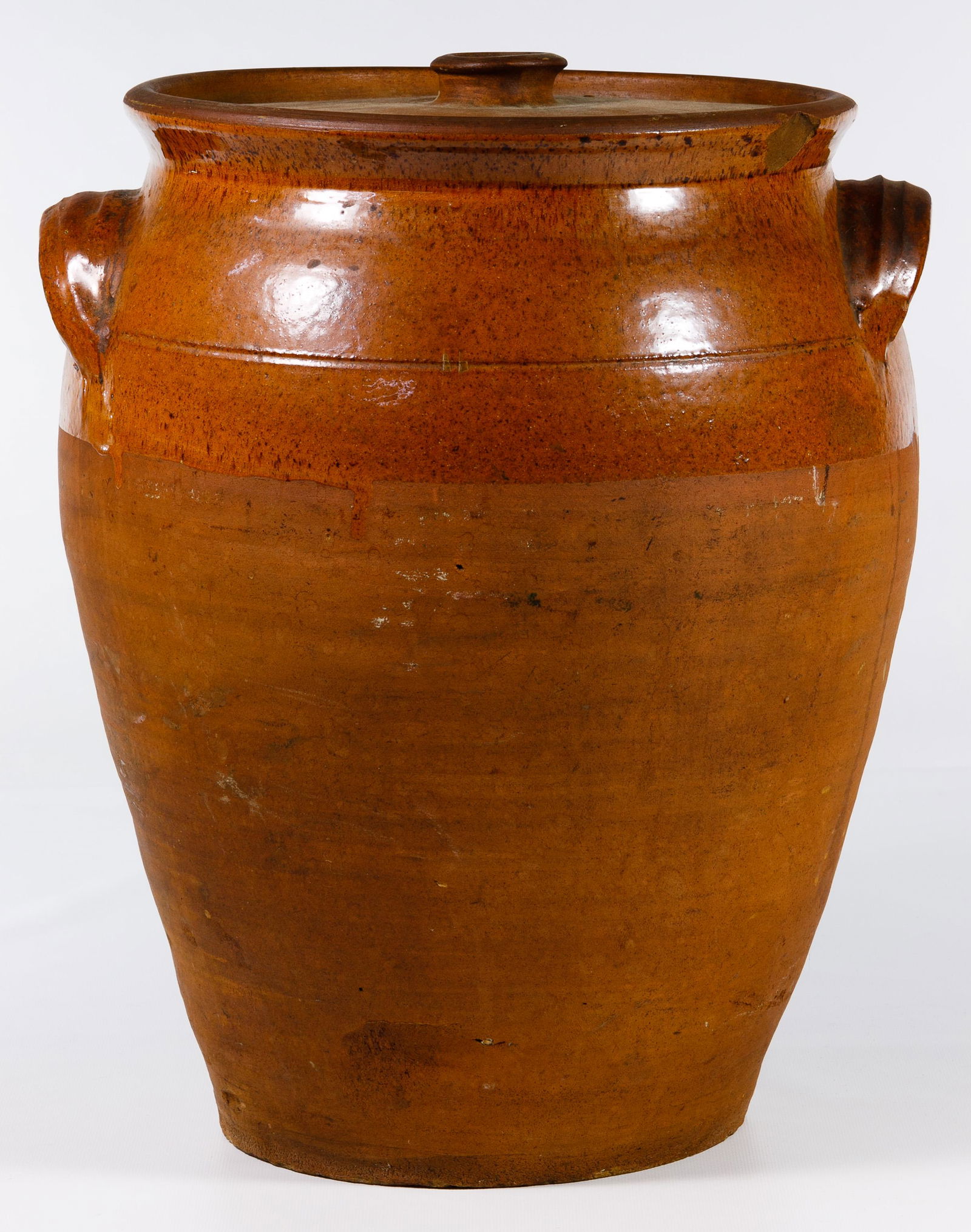 Redware Butter Churn: Redware Butter Churn Terracotta having an unglazed bottom and lid, glazed interior and lug handles Condition: Good, light to moderate wear, chip on rim, chips on lid; please note: this lot came from a