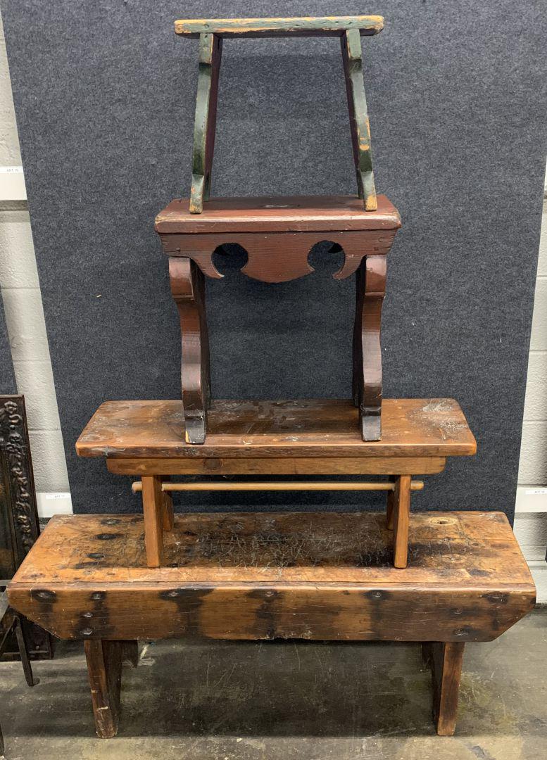 Primitive Bench Assortment: Primitive Bench Assortment Four hand carved benches, the smallest retaining old red and green paint; a carved with scalloped details, a hand hold top, red paint; one having a dowel rod brace, the larg