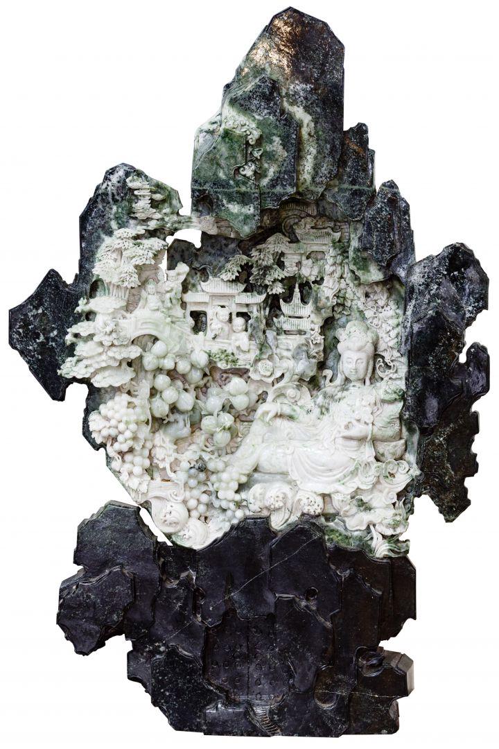 Chinese Carved Jadeite Jade Intricate Sculpture: Chinese Carved Jadeite Jade Intricate Sculpture Variegated jadeite jade intricately carved floor sculpture, depicting a Guanyin seated in the â€œRoyal Ease” position along with several other