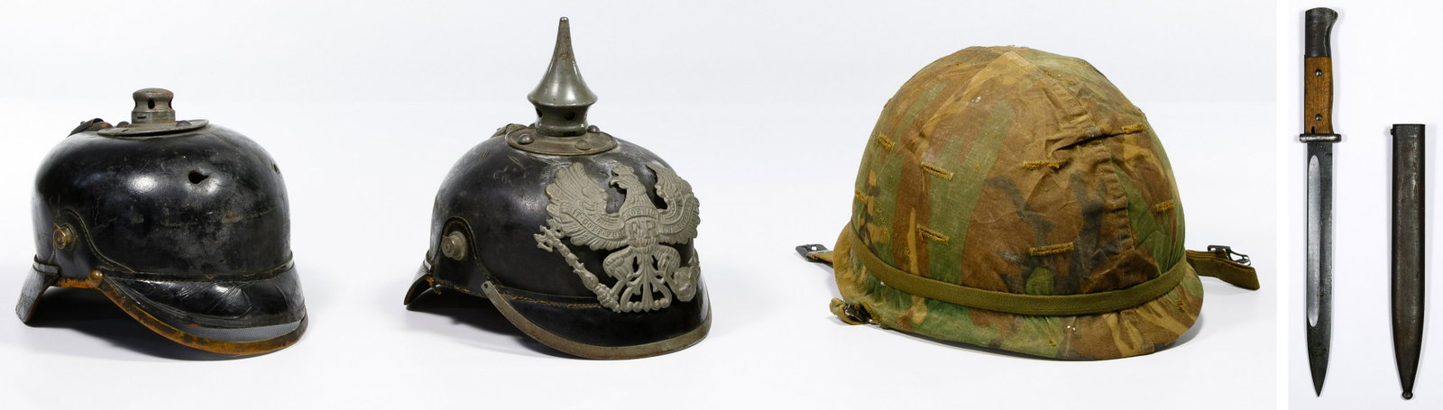 World War I German Prussian Pickelhaube Spiked Helmets: World War I German Prussian Pickelhaube Spiked Helmets Two Prussian enlisted man helmets; together with a World War II German Cof 43 bayonet having a matching number metal scabbard and a Korean War US