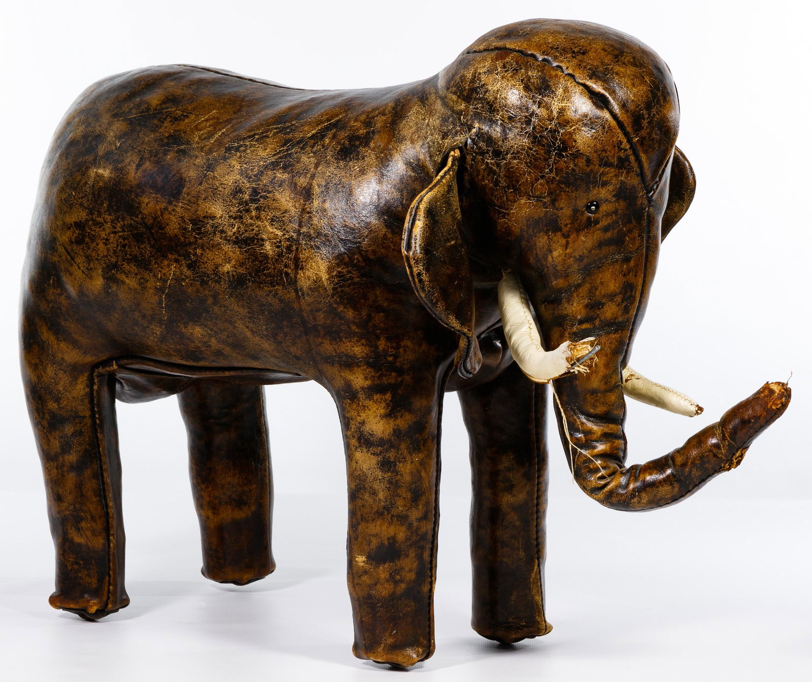 Dmitri Omersa for Liberty's of London Leather Elephant: Dmitri Omersa for Liberty's of London Leather Elephant Footstool 20th century, leather footstool in the form of an elephant with tusks, marked on left ear Condition: Good, leather showing traces of ag