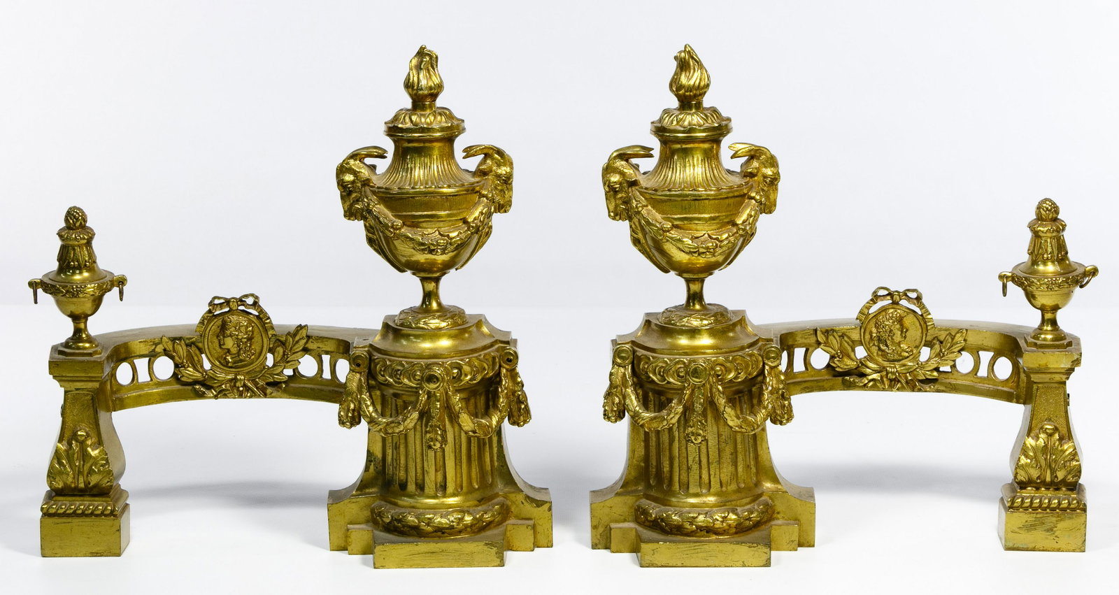 Napoleon III Style Gilt Bronze Andirons: Napoleon III Style Gilt Bronze Andirons Two pedestal andirons having classical motifs of columns, vases, swags and rams heads Condition: Very Good, overall light wear consistent with age and normal us