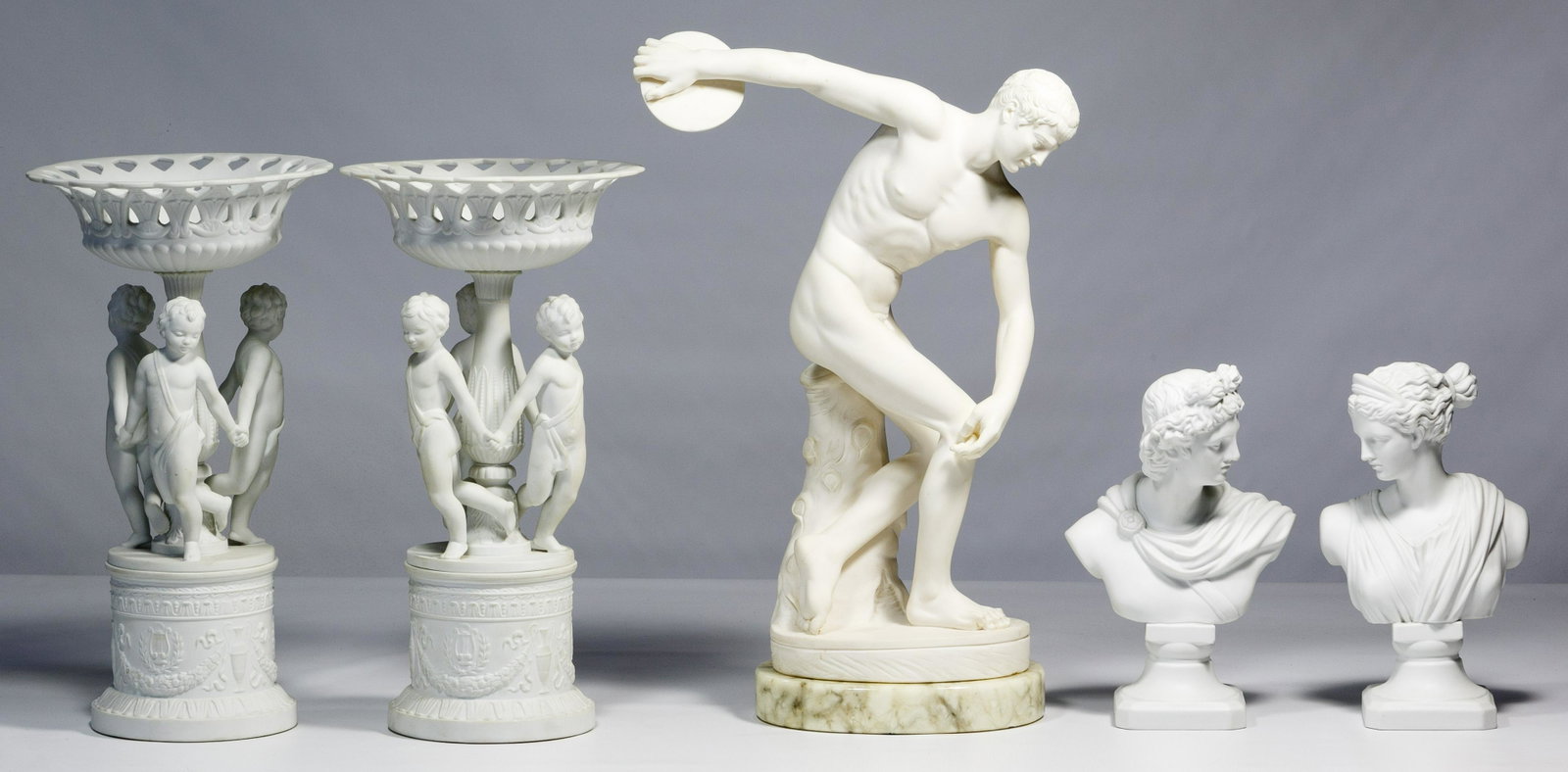 White Bisque Porcelain Assortment: White Bisque Porcelain Assortment Five items including a pair of mantel pedestals marked Bidasoa Spain, two female busts and a male discus thrower statue on marble Condition: Very Good, no chips or cr