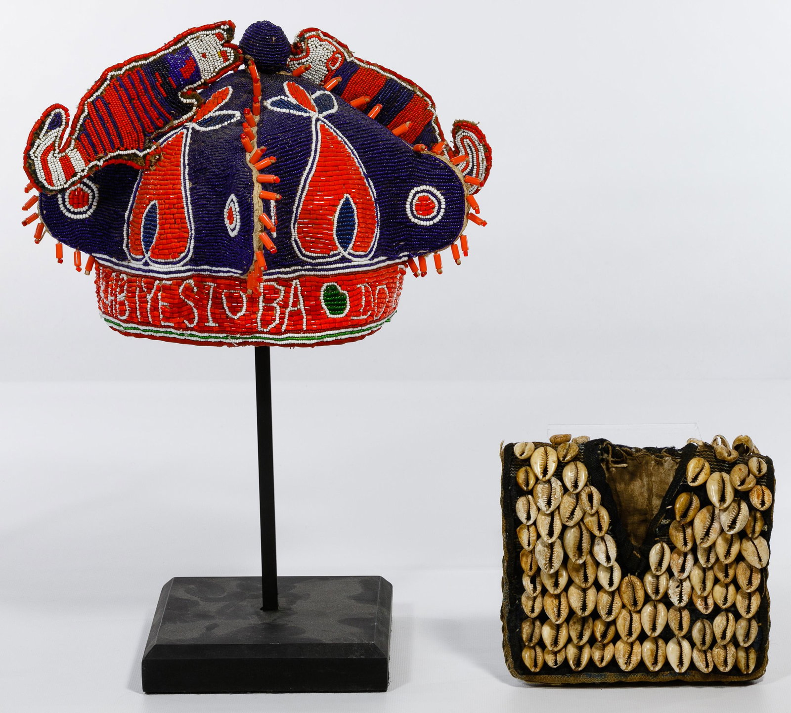 African Beaded Headdress and Vest: African Beaded Headdress and Vest Two items including a beaded ceremonial headdress reading 'kabiyesioba doowa loia' (take care of the king) mounted on a metal display stand; and a small vest beaded w