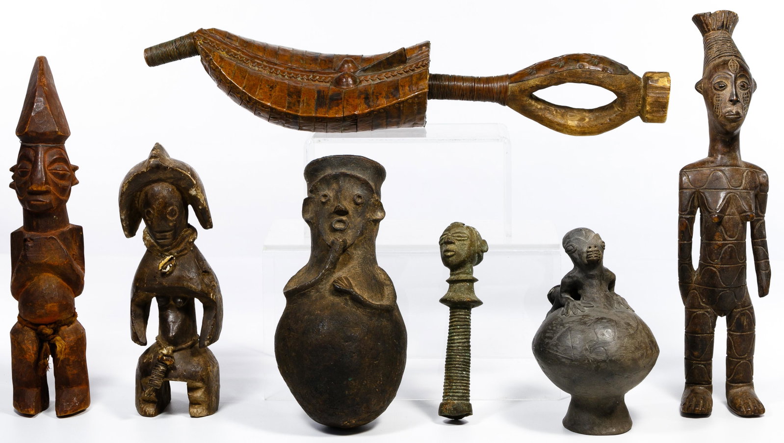 African Carving Assortment: African Carving Assortment Seven hand-made items including three carved wood figures, a frog figure on a mushroom, a carved figure vessel, metal head sculpture top and a Kota reliquary wand from Gabon