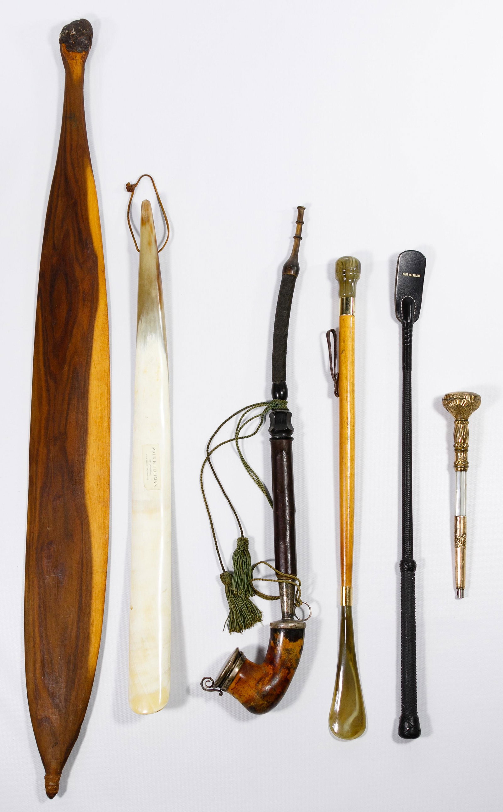 Woomera Spear and Shoehorn Assortment: Woomera Spear and Shoehorn Assortment Six items including a carved wood Woomera spear, a carved bone shoehorn and an Italian plastic and wood shoehorn with leather and brass accents; together with an 