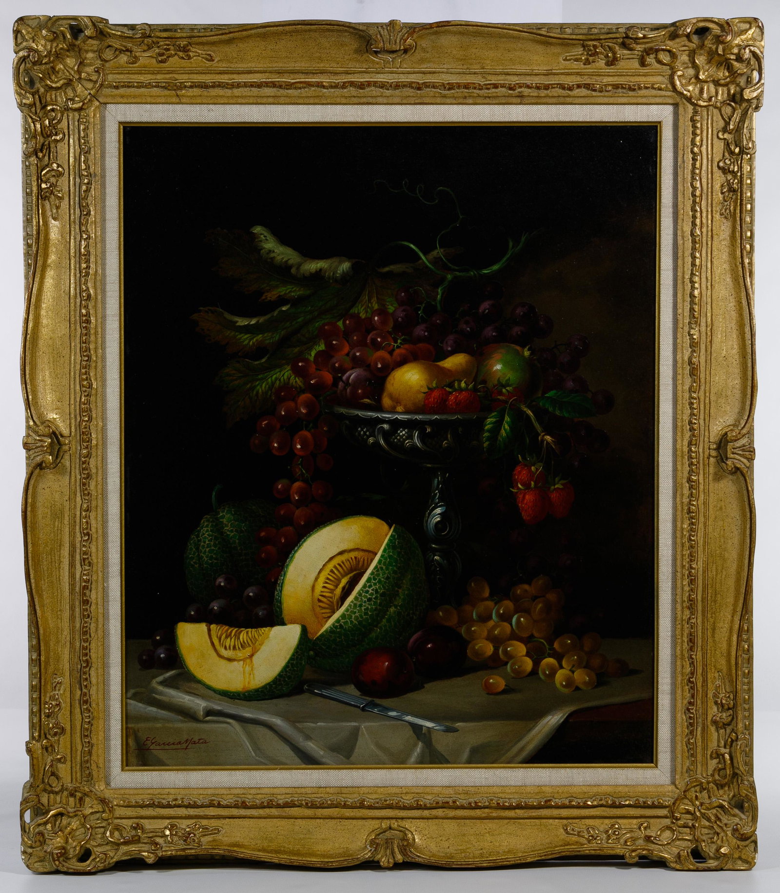 E. Garcia Mata (Cuban / American, 1910-1985) Oil on: E. Garcia Mata (Cuban / American, 1910-1985) Oil on Masonite Undated, signed lower left, still life depicting a pedestal bowl of fruit atop a table; gilt frame Condition: Very Good, no damage to art n