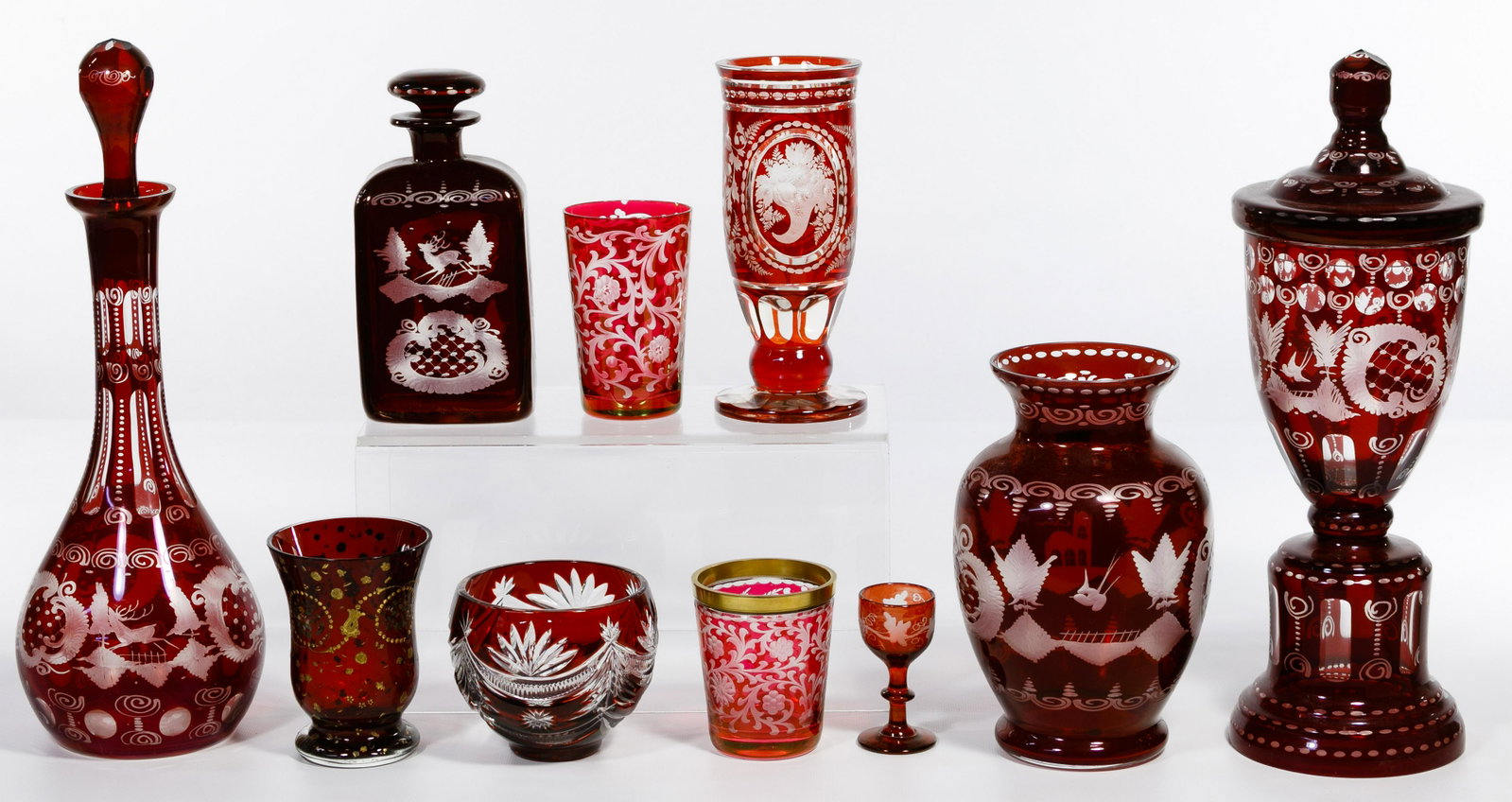 Czech Etched Red Glass Assortment: Czech Etched Red Glass Assortment Ten items including eight etched Czech glass having botanical and landscape motifs and including three vases with one having a lid, two decanters having stoppers, a c