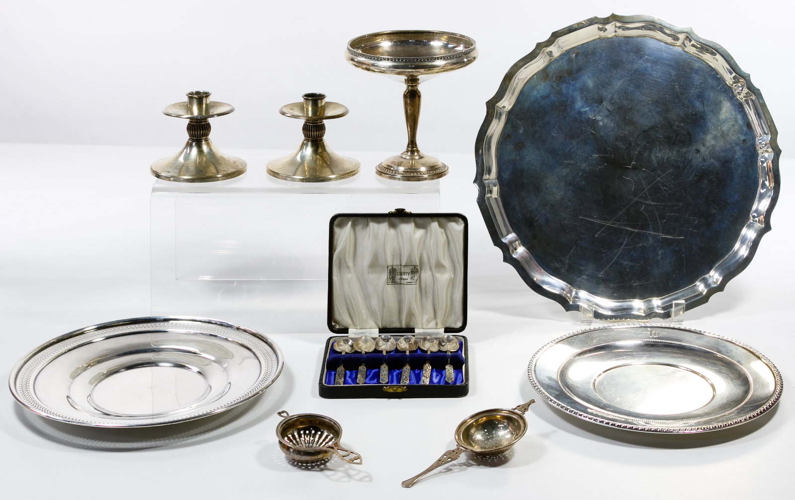 Sterling Silver Hollowware and Flatware Assortment: Sterling Silver Hollowware and Flatware Assortment Fourteen items including three trays, two candle sticks, two tea strainers, a compote, six demi-tasse spoons in a case; all marked 'sterling', some w