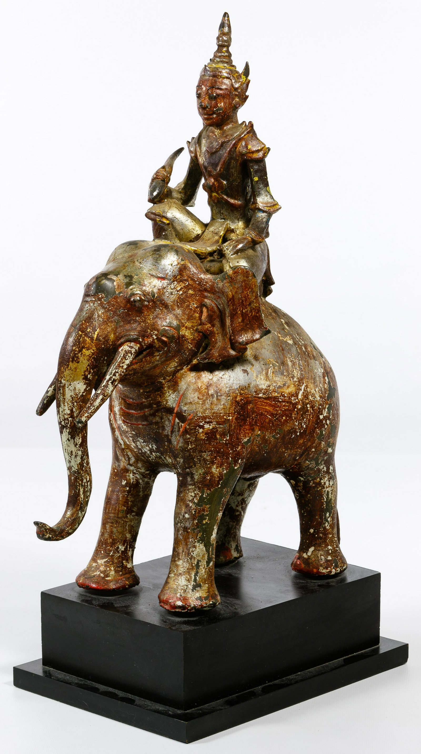 Burmese Bronze Elephant Statue: Burmese Bronze Elephant Statue 19th century silvered bronze statue of a deity riding an elephant, mounted on a wooden plinth; accompanied by original bill of sale from a Bangkok gallery Condition: Ver