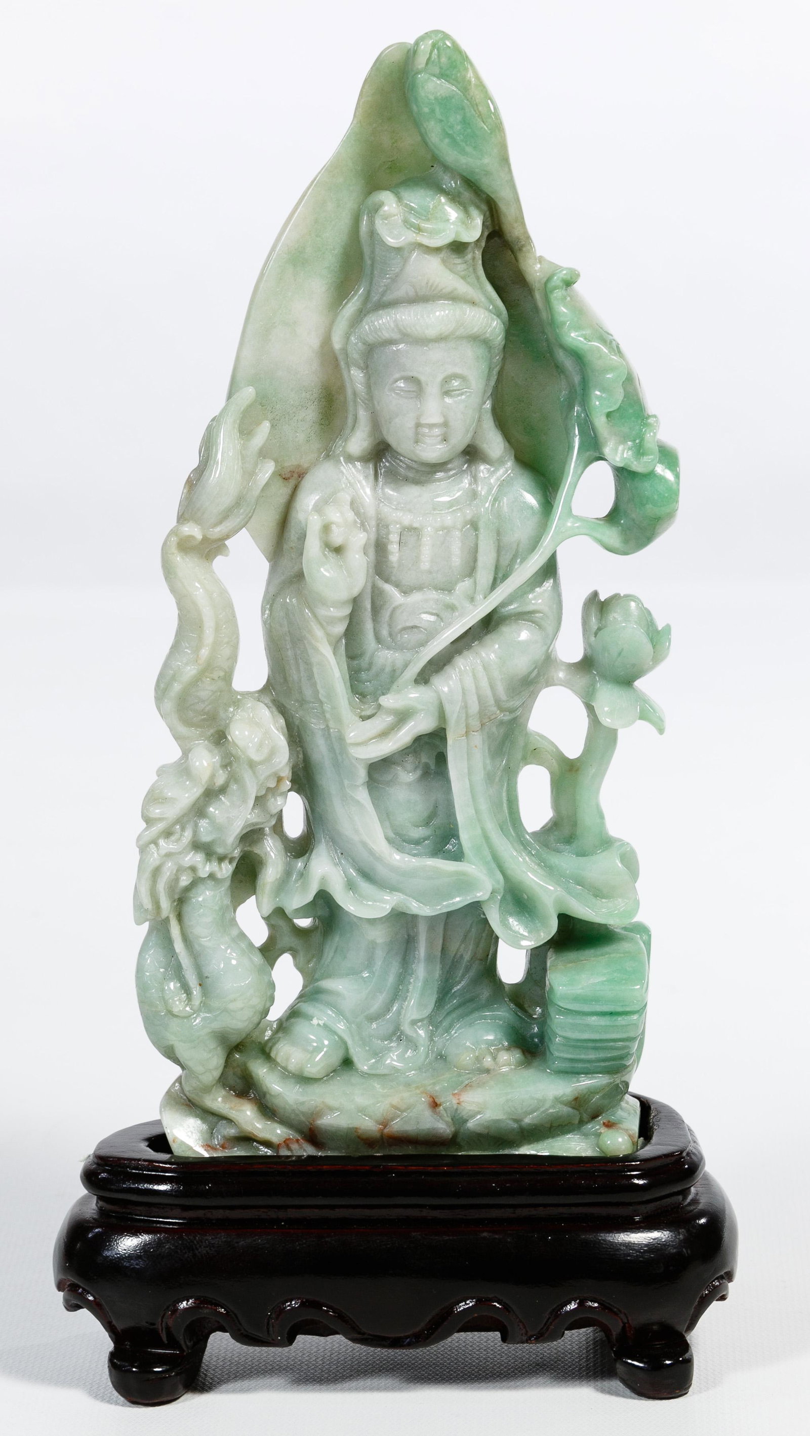 Chinese Jadeite Jade Guanyin Carving: Chinese Jadeite Jade Guanyin Carving Detailed carving depicting Kuan Yin having a peony on one side, a dragon on one side, holding a lotus flower, light green color with darker green and brown suffusi