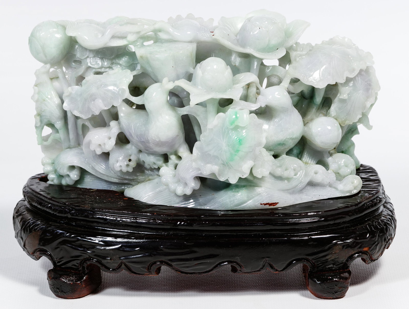 Chinese Jadeite Jade Lotus Blossoms Carving: Chinese Jadeite Jade Lotus Blossoms Carving Detailed carving depicting two birds among lotus blossoms, gray lavender color having some emerald color suffusions, hand carved stand having black lacquere