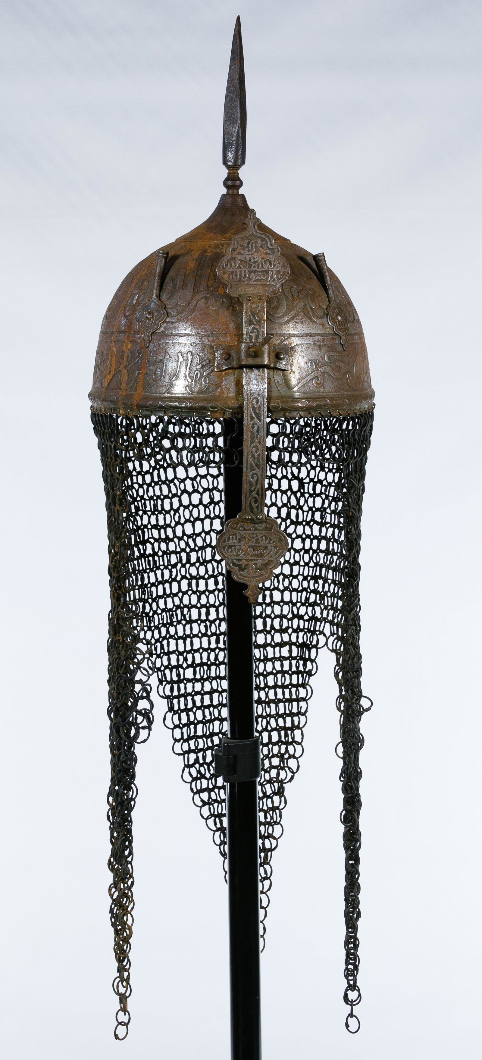 Indo-Persian Kulah-Khud Style Helmut on Stand: Indo-Persian Kulah-Khud Style Helmut on Stand Having relief decoration, circular link chain mail drape and red felt lining, on stand Condition: Good, areas of rust overall; a chain mail link detached 