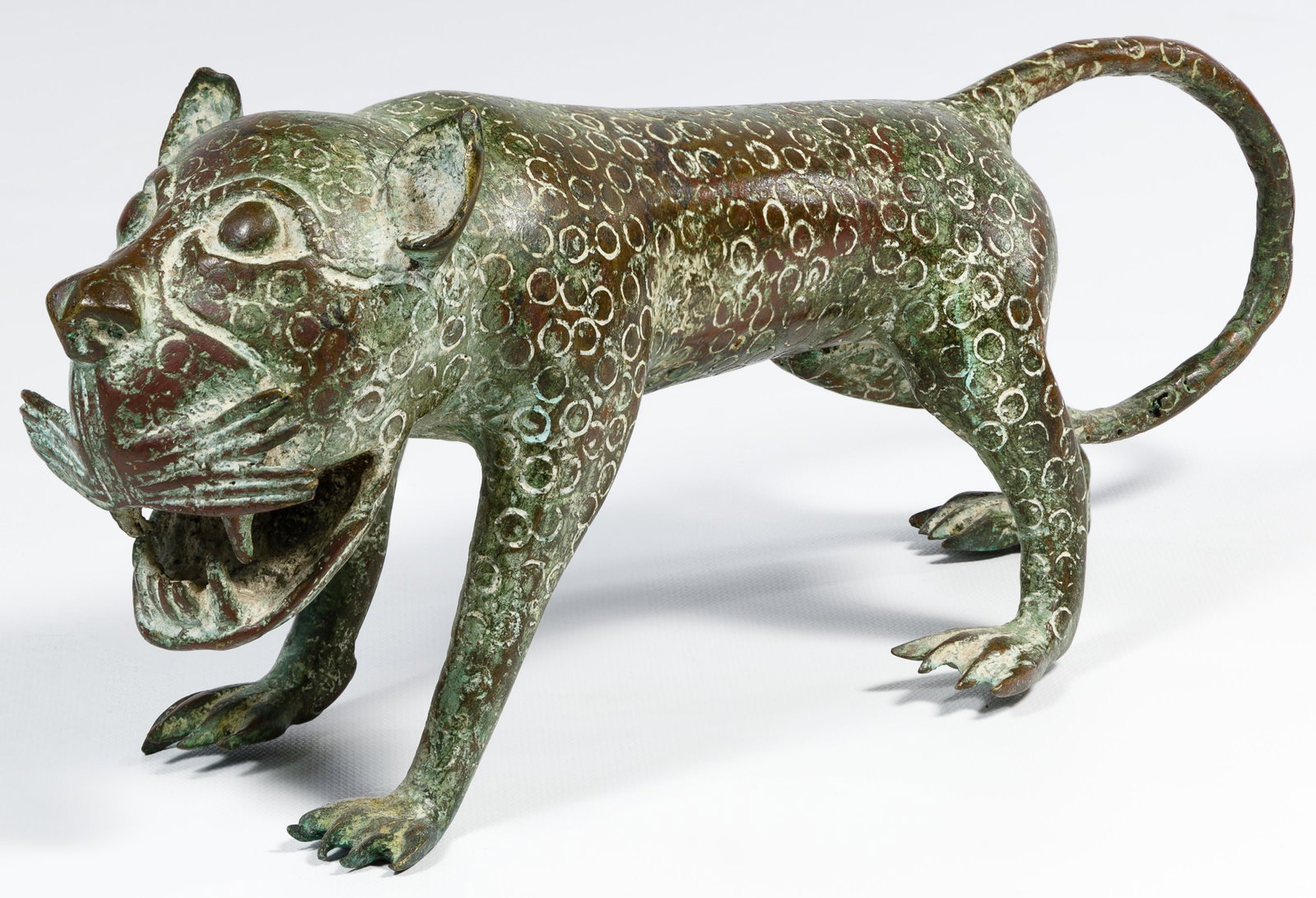 African Nigerian Bronze Leopard Figure: African Nigerian Bronze Leopard Figure Cast and assembled bronze depicting an male leopard walking with an open mouth, some verdigris together with bill of sale Condition: Very Good, overall light wea