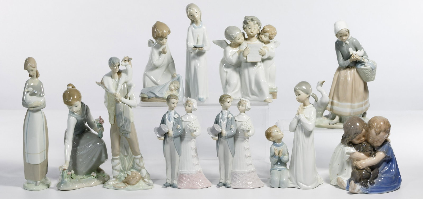 Lladro Figurine Assortment: Lladro Figurine Assortment Including #4506 'Shepherd Boy with Goat' retired 1985 with box; #1172 'Girl with Flowers' retired 1993 with box; (2) #4808 'Wedding' retired 2004 with a box; #4779 'Teaching